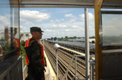National Guardsmen stands watch over rail yard.