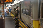 National Guardsmen search for potential threats during a patrol of the New York Subway System.