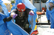  Members of the Utah National Guard's 85th Weapons of Mass Destruction Civil Support Team decontaminate a fellow team member at a mock disaster site in Ogden, Utah, during Operation Vigilant Guard. (Photo by SPC Chris Gardner, Utah National Guard)