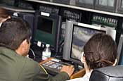 A Border Patrol agent and a National Guard Citizen-Soldier monitor surveillance equipment at the Nogales Border Patrol Station in Nogales, Ariz., on Jan. 17, 2007. Linked to cameras and sensors along the U.S. border with Mexico, the equipment allows agents and Guardmembers to detect suspected illegal aliens and smugglers. Up to 6,000 Guardmembers are helping the Border Patrol secure the border under Operation Jump Start. (U.S. Army photo by Sgt. Jim Greenhill)