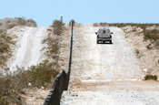 A Border Patrol agent drives past new vehicle barriers near Deming, N.M., built by U.S. Army Soldiers with the 133rd Engineer Company, Wyoming National Guard June 17, 2006. (U.S. Army photo by Sgt. Jim Greenhill)