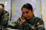 A National Guard member, of 2nd Battalion, 200th Infantry Regiment, New Mexico National Guard, takes phone calls at the National Guard Armory in Deming, N.M., June 19, 2006. Her unit is assisting the Border Patrol with border-security operations. (U.S. Army photo by Sgt. Jim Greenhill)