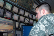 An Arizona National Guard member monitors surveillance screens at the Border Patrol communications center in the Yuma Sector of Arizona on June 20, 2006. The Soldiers from 1st Battalion, 158th Infantry Regiment, are assisting the Border Patrol with border-security operations. (DoD photo by Sgt. Jim Greenhill, U.S. Army.)