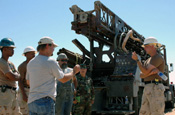 Civilian contractors and U.S. Army Soldiers from the 257th Engineer Detachment, Arizona National Guard, discuss a well-drilling project June 20, 2006, within the U.S. Border Patrol's Yuma sector in Arizona. The well and two others like it, to be dug near the Mexican border, will improve the water supply for U.S. National Guardsmen and Border Patrol agents working in the remote area. DoD photo by Sgt. Jim Greenhill, U.S. Army.
