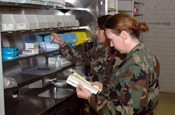 Members of a West Virginia Air National Guard medical team, who are not identified for security reasons, restock a medical clinic in Playas, N.M. The clinic is being set up to treat personnel participating in Operation Jump Start, the National Guard's support to the Customs and Border Patrol. (Photo by Sgt. Jim Greenhill, National Guard Bureau)