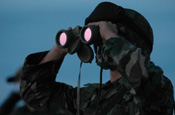 A member from the North Carolina Army National Guard, looks through his binoculars at an area of the Mexican border in San Luis, Ariz., July 26, 2006. National Guard Soldiers are working with the U.S. Border Patrol in support of Operation Jump Start. (U.S. Air force photo by Tech. Sgt. Brian E. Christiansen)