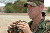 U.S.- Mexican Border, Southwestern Arizona. A National Guard member performs his observation duties on July 27, 2006. There are over 200 Soldiers assigned to the 1-252 Combined Arms Battalion, North Carolina Army National Guard, who are continuously standing by and observing an area of the border. The unit is currently deployed here for thier annuall training observing the border, and are working with U.S. Border Patrol in support of Operation Jump Start. Photo by Tech Sgt Brian E. Christiansen, North Carolina Air National Guard.