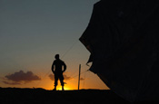 A National Guard member scans the horizon at the U.S.-Mexican border in San Luis, Ariz., July 30, 2006. More than 200 Soldiers assigned to the 252nd Combined Arms Battalion, North Carolina Army National Guard are deployed to Marine Corps Air Station Yuma, Ariz., to train and work with the U.S. Border Patrol in support of Operation Jump Start. (U.S. Air Force photo by Tech. Sgt. Brian E. Christiansen)
