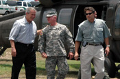 President George Bush shares laugh with LTG H Steven Blum, chief of the National Guard Bureau at McAllen International Airport during the president's visit to National Guard troops participating in Operation Jump Start on Aug. 3, 2006. Texas Gov. Rick Perry is at right. (Photo by Sgt. Jim Greenhill, National Guard Bureau)
