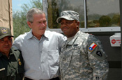 President George Bush talks with a Texas Army National Guard Soldier at a border observation point while visiting National Guard troops who are participating in Operation Jump Start at the U.S. Mexican border in Mission, Texas, on Aug. 3, 2006. (Photo by Sgt. Jim Greenhill, National Guard Bureau)