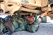 ALONG THE U.S.-MEXICO BORDER, WEST OF YUMA, Ariz.) (Sept. 12, 2006) A member of the Washington National Guard, performs a routine maintenance inspection of a military vehicle while on duty with an Entry Identification Team at an observation post along the U.S.-Mexico border near Yuma, Ariz. Soldiers and airmen from the Washington National Guard are manning a series of observation posts along the U.S.-Mexico border as part of Operation Jump Start. Under the Operation, National Guard Soldiers and airmen from around the nation are working with the U.S. Border Patrol to help secure the nation's southern border. Guardsmen and women are building and repairing fences, adding lighting in key areas and manning a series of observation posts along the border. (U.S. Army photo by Pvt. 1st Class Monette Wesolek.)