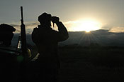 Sasabe, AZ, a member of the NC Army National Guard, Task Force Scorpion watches the Mexican border for any type of activity in the early morning hours. After sunset the temperature falls from about 120 to about 60 degrees. Photo by Spec. Jessica L. Sheldon