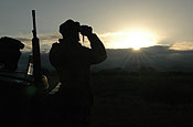 Sasabe, AZ, a member of the NC Army National Guard, Task Force Scorpion watches the Mexican border for any type of activity in the early morning hours. After sunset the temperature falls from about 120 to about 60 degrees. Photo by Spec. Jessica L. Sheldon