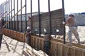 U.S. Air Force airmen install a fence along the U.S.-Mexico border east of San Luis, Ariz., on Oct. 3, 2006. The Guardsmen are working in partnership with the U.S. Border Patrol as part of Operation Jump Start. The airmen are assigned to the 188th Fighter Wing Arkansas Air National Guard. (DoD photo by Staff Sgt. Dan Heaton, U.S. Air Force.)