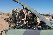 A U.S. Army Pfc., left, and a U.S. Air Force Tech. Sgt., both with the Pennsylvania National Guard, perform an engine inspection on their vehicle in Yuma, Ariz., Oct. 16, 2006, during a desert driving training exercise. More than 6,000 National Guardsmen from across the nation are working in partnership with the U.S. Border Patrol as part of Operation Jump Start. (DoD photo by Staff Sgt. Dan Heaton, U.S. Air Force)