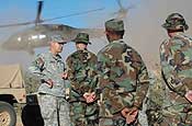Visiting the Troops - Maj. Gen. Ron Chastain, the adjutant general of Arkansas, visits with the 15 Arkansas Air National Guardsmen serving on the border mission in Arizona. An Arizona National Guard Blackhawk helicopter takes off in the background after dropping of the general and his contingent of leadership from the Arkansas Guard. (Photo by Capt. Chris Heathscott, Arkansas National Guard State Public Affairs Office)