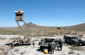 National Guard members in an entry identification team man their post on Johnson Mountain in New Mexico. The team gathers intelligence about possible undocumented aliens attempting to enter the United States from Mexico and relays it to Border Patrol agents. Mexico is south of the ridge. The skybox provides Soldiers with a higher vantage point and contains equipment that enhances their ability to see people by day and night. (Photo by Sgt. Jim Greenhill, National Guard Bureau)