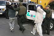 Border Patrol agents apprehend suspected illegal aliens, who have just crossed the U.S. border with Mexico through a storm drain, in downtown Nogales, Ariz., on Jan. 17, 2007. National Guard Citizen-Soldiers and Airmen participating in Operation Jump Start monitor electronic surveillance equipment in remote control rooms and watch the border from observation posts, acting as the Border Patrol's eyes and ears. Since July 2006, information gathered by Guardmembers has helped the Border Patrol to apprehend more than 1,900 suspected illegal aliens or smugglers at the Nogales Station alone. Guardmembers do not come into direct contact with suspected aliens or smugglers. (U.S. Army photo by Sgt. Jim Greenhill)