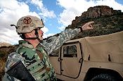 A Tennessee Army National Guard Soldier, who is not being identified for security reasons, points to a hilltop, Friday, Jan. 19, 2007, in the U.S. Border Patrol's Sasabe District in Arizona where he heard gunfire prior to an incident involving armed individuals approaching a National Guard Entry Identification Team near the U.S. border with Mexico. After moving to a safer location to observe the individuals, the team reported the incident to the Border Patrol. (U.S. Army photo by Sgt. 1st Class Gordon Hyde)