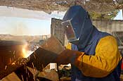 An Oregon Army National Guard Soldier, of Portland, Ore., from Echo Company (Civil Engineer Unit), 3rd Battalion, 116th Calvary, based in Prineville, Ore., welds a railroad tie into place to create a vehicle barrier south of Sasabe, Ariz., on Jan. 19. The Guardsman is working in Arizona as part of Operation Jump Start, supporting U.S. Customs and Border Patrol. The barriers will be used to prevent vehicles from illegally crossing the Arizona-Mexico border. (U.S. Air Force photo by Senior Airman Trish Harris, 142nd Fighter Wing - Visual Information)