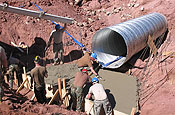 NOGALES, Ariz. South Dakota Army National Guardsmen, supporting the Southwest Border Patrol by participating in Operation Jump Start, are continuing their assigned mission to complete the construction of a 1.5 mile section of road just east of the town of Nogales along the U.S.-Mexico border. Members of the 842nd Engineer Company emplace concrete for a pad on a 60 inch culvert. (Army National Guard photo by Warrant Officer Brian Maschino)