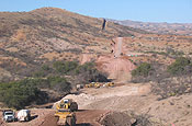 NOGALES, Ariz. South Dakota Army National Guardsmen, supporting the Southwest Border Patrol by participating in Operation Jump Start, are continuing their assigned mission to complete the construction of a 1.5 mile section of road just east of the town of Nogales along the U.S.-Mexico border. This is a view of the 1.5 mile road project from the top side; border fence is in the top left of the photo. (Army National Guard photo by Warrant Officer Brian Maschino)