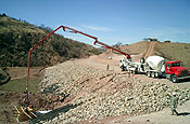 NOGALES, Ariz. South Dakota Army National Guardsmen, supporting the Southwest Border Patrol by participating in Operation Jump Start, are continuing their assigned mission to complete the construction of a 1.5 mile section of road just east of the town of Nogales along the U.S.-Mexico border. A concrete pump truck was called in to place concrete for the head wall of the first 60 inch culvert. (Army National Guard photo by Warrant Officer Brian Maschino)