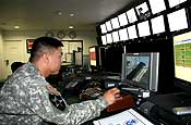 A California National Guardsmen keeps a vigilant watch in the Border Patrol's Radio Video Surveillance room. His job is to monitor a series of cameras strategically placed along the fence-line. (U.S. Army photo by Sgt. 1st Class Gordon Hyde)