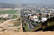 A small fence separates densely populated Tijuana, Mexico, right, from the United States in the Border Patrol's San Diego Sector. Construction is underway to extend a secondary fence over the top of this hill and eventually to the Pacific Ocean. (U.S. Army photo by Sgt. 1st Class Gordon Hyde)