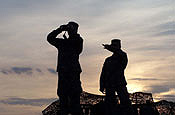 (ALONG THE U.S.-MEXICO BORDER) (30 JULY 06) Two soldiers from the Tennessee National Guard are silhouetted against the morning sky while on duty along the U.S.Mexico border, near Yuma, Ariz. The Guardsmen are working as part of an EIT Entry Identification Team along the border, providing an extra set of eyes and ears for the U.S. Border Patrol. The National Guard is working along the southern U.S. Border as part of Operation Jump Start. (U.S. Air Force photo by Staff Sgt. Dan Heaton)
