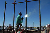 (ALONG THE U.S.-MEXICO BORDER, NEAR YUMA, ARIZ.) (02 AUG 06) An Airman with the Kansas Air National Guard welds a connection plate to a piece of a wall being built by the National Guard along the U.S. Mexico border in southern Arizona. The wall is being built by the National Guard as part of Operation Jump Start, in which the National Guard is working with the U.S. Border Patrol to secure the nation's southern border. The cars seen in the background are parked in Mexico. Previously this area, just west of San Luis, Ariz., had no fence to guard the U.S. border. (U.S. Air Force photo by Staff Sgt. Dan Heaton)
