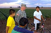 Lt. Gen. H Steven Blum, chief, National Guard Bureau, chats with neighborhood children at the U.S. border with Mexico near San Luis, Ariz., on Nov. 27, 2006, during a visit to troops participating in Operation Jump Start. Up to 6,000 National Guard members are helping the Border Patrol secure the nation's southern border. Blum approached the boys and chatted with them about borderland life and the National Guard operation. Arizona National Guard UH-60 Black Hawks are in the background. U.S. Army photo by Sgt. Jim Greenhill