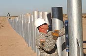 Unidentified workers construct a vehicle barrier that will secure the border between the United States and Mexico. The National Guard and US Customs and Border Protection Agency are working together to bolster security along the border. (USAF Photo/Master Sgt Gerold O. Gamble)