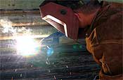 September 21, 2006 - A member from the Arizona Army National Guard, welds a piece of metal over a hole in the fence along U.S./Mexico border near San Luis, Ariz. This photo appeared on www.army.mil.(Photo by Air Force Staff Sgt. Dan Heaton)