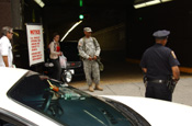 SGT Norberto Reyes, HSC 642nd Division Avn Spt Bn in the entrance of the Grand Central Station Parking Garage. NCOIC SSG Illa Galloway, 1569th Trans Co also appears. (Photo by Paul Fanning, New York National Guard)