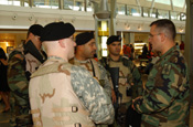 JFK Airport, NY, Terminal 4. LT Gerald Steckmeister joins PFC LaShure, SGT Garcia, SPC Brian Sanchez and PFC Frank Battista. All are assigned to the 101st Signal Battalion. US customs and Border Protection Officer Michael Rivera joins the group. (Photo by Paul Fanning, New York National Guard)