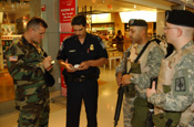 JFK Airport, NY, Terminal 4. LT Gerald Steckmeister joins PFC LaShure, SGT Garcia, SPC Brian Sanchez and PFC Frank Battista. All are assigned to the 101st Signal Battalion. US customs and Border Protection Officer Michael Rivera joins the group. (Photo by Paul Fanning, New York National Guard)