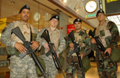 JFK Airport, NY, Terminal 4. LT Gerald Steckmeister joins PFC LaShure, SGT Garcia, SPC Brian Sanchez and PFC Frank Battista. All are assigned to the 101st Signal Battalion. US customs and Border Protection Officer Michael Rivera joins the group. (Photo by Paul Fanning, New York National Guard)