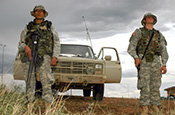 Arizona Army National Guard Soldiers stand watch on the U.S. border with Mexico at Nogales, Ariz. The Citizen-Soldiers are members of Alpha Company, 1st Battalion, 158th Infantry Regiment, 29th Infantry Brigade Combat Team participating in Operation Jump Start, the National Guard's assistance to the U.S. Border Patrol. National Guard troops who carry weapons are armed for self-defense purposes only. (Photo by Sgt. Jim Greenhill, National Guard Bureau)