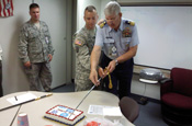 Army Sgt. Stephen Pursley, a law enforcement operations non-commissioned officer for the National Guard Bureau, and Cmdr. John Hooper, the U.S. Coast Guard liaison to the National Guard Bureau, cut a cake celebrating the 220th birthday of the U.S. Coast Guard at the Guard headquarters in Arlington, Va., Aug. 4, 2010. (Courtesy photo)