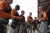 Master Sgt. Chris Grall of the Florida National Guard's Counterdrug Training Academy (right) prepares his team for competition at the 2008 SWAT Round-up International Competition in Orlando, Fla., Dec. 4, 2008. Photo by Tech. Sgt. Thomas Kielbasa.