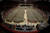 32nd Brigade Command Sgt. Maj. Ed Hansen, on floor in front of podium, accepts reports from battalion command sergeants major as the brigade forms at the start of the Feb. 17 send-off ceremony at the Dane County Veterans Memorial Coliseum, Madison, Wis. Family members and public officials bade farewell to some 3,200 members of the 32nd Infantry Brigade Combat Team and augmenting units, Wisconsin Army National Guard, in the ceremony. The unit is bound for pre-deployment training at Fort Bliss, Texas, followed by a deployment of approximately 10 months for Operation Iraqi Freedom. Wisconsin Department of Military Affairs photo by Larry Sommers.