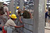 Sgt. 1st Class Catherine Kula of Waipahu, Hawaii and Thai marine PO1 Prawet Asasoy check to make sure the freshly built wall is plumb, or straight, in the new classroom facility the Hawaii National Guard, 230th Engineer Company, Vertical is building jointly with the Royal Thai Marine Engineer Battalion during the Cobra Gold joint engineering civil assistance mission hosted at the Ban Nong Buatong school in the Chanthaburi District of Thailand Jan. 24 to Feb. 11.