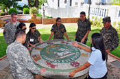 Honduran public affairs Soldiers observe a mosaic of Puerto Rico's crest during a visit to the governor's mansion in Old San Juan. The visit of the Honduran military was part of the State Partnership Program in which they had the opportunity to visit the Puerto Rico National Guard training facilities and exchange training information with its leaders. (Army National Guard photo by Staff Sgt. Joseph Rivera-Rebolledo)