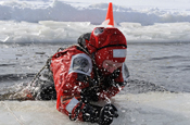  A Canadian Army Reservists climbs out of a frozen lake during winter warfare training. (Courtesy Photo)