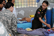  Cambodian Capt. Prum Sanghoun, a Royal Cambodian Armed Forces doctor, explains the care of a patient to Army Staff Sgt. Erin Smith, a medic with the Idaho National Guard's Charlie Company, 145th Brigade Support Battalion, during a tour of the Phnom Penh Military Hospital June 27, 2012. The Idaho National Guard conducted the subject matter expert exchange as part of its ongoing relationship through the National Guard Bureau's State Partnership Program with the Royal Kingdom of Cambodia. (Army National Guard photo by Capt. Tony Vincelli)
