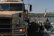 Soldiers from South Dakota Army National Guard's 200th Engineer Company loaded military vehicles and Soldiers from the 1133rd Transportation Battalion, Iowa Army National Guard, onto five float ribbon-bridge rafts and transported them across the water on Sunday, June 10, at the Missouri River in Chamberlain. The units being shuttled across the river will participate in the 2007 Joint Thunder Exercise. The exercise provides relevant training opportunities in support of the Global War on Terror and Homeland Defense, and is being held June 9–23 in the Northern Black Hills of South Dakota. More than 4,300 service members from 81 units representing 34 states are expected to participate in the 23rd annual Joint Thunder Exercise. Army National Guard photo by Sgt. 1st Class Donald Matthews.