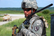  Staff Sgt. Bryan Dykes, is calls on his radio for a medical evaluation on a “wounded” Soldier during a training exercise at Camp Atterbury, Ind. (U.S. Army photo by Sgt. William Hill)