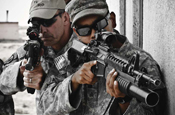 American soldiers demonstrate the proper way to stack on a wall for room clearing to their Iraqi counterparts.