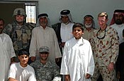 1st Lt. Josh Fjelstad, Field Civil Military Operations Officer, 1-34 Brigade Troops Battalion (left) and Lt. Col P. G. Sims, Deputy Division Civil Military Effects officer of Multi National Division Southeast with local elders of Um Eneej, Iraq at the new school and truck stop projects in southern Iraq. Photo by Spc. Brian D. Jesness, 1/34 BCT Public Affairs.